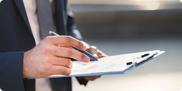 a man writing on a clipboard